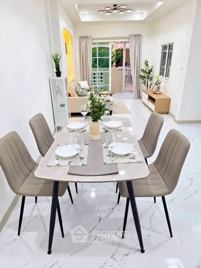 Modern dining and living area with elegant decor and natural light