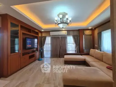 Spacious living room with elegant lighting and modern furniture, perfect for relaxation and entertainment.