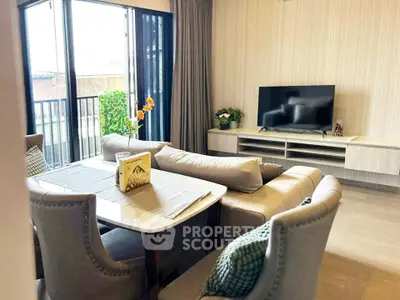 Modern living room with stylish furniture and large windows offering natural light.