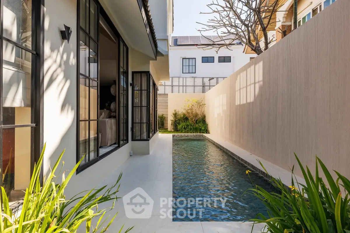 Luxurious private pool with modern architecture and lush greenery, perfect for relaxation and entertainment.