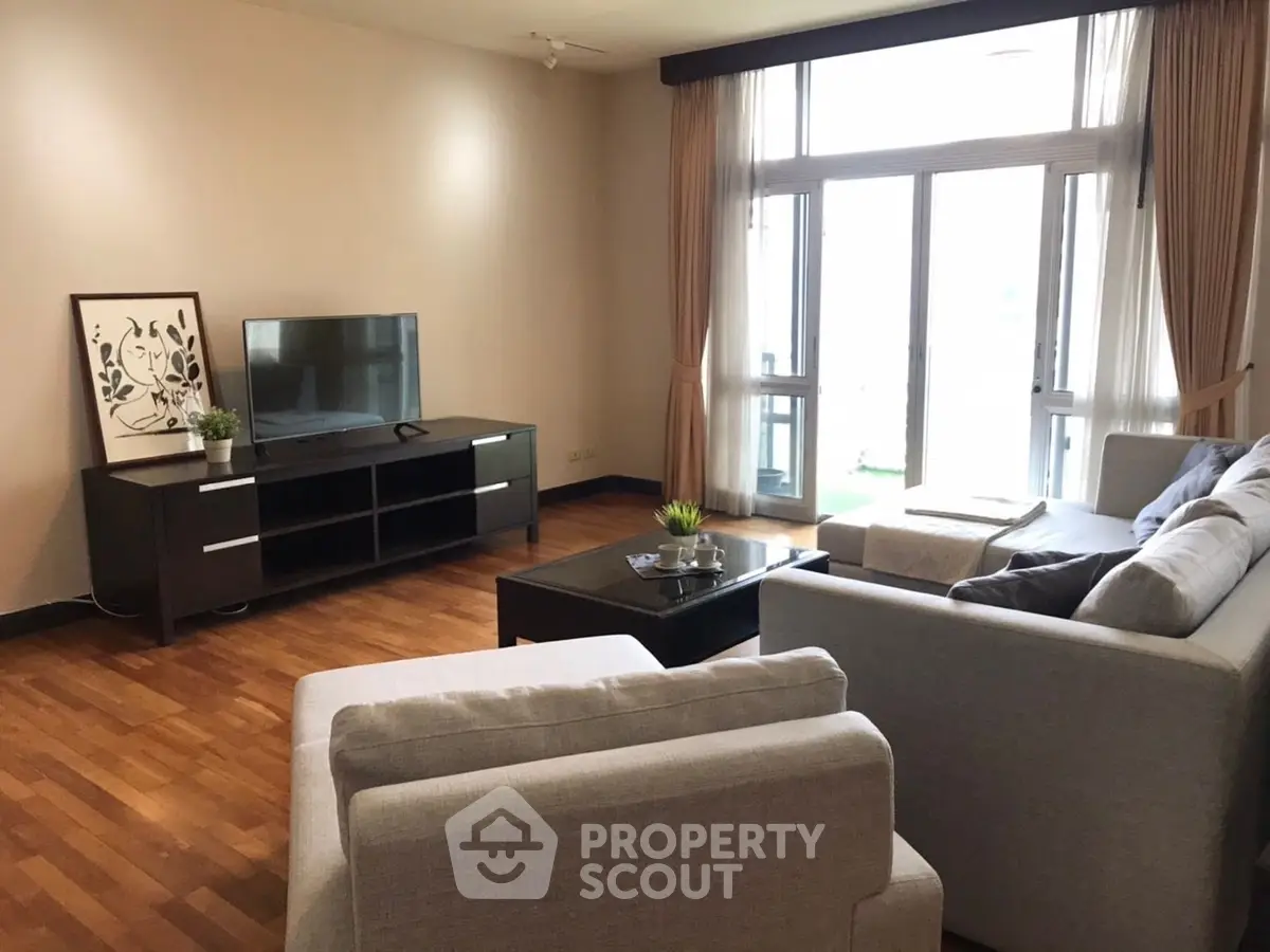 Spacious living room with modern furniture and large windows for natural light.