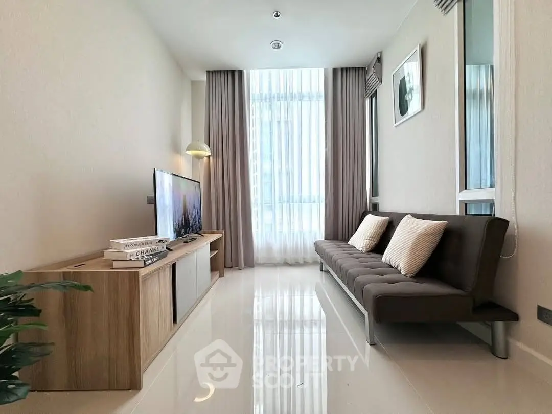 Modern living room with sleek furniture and large window for natural light.