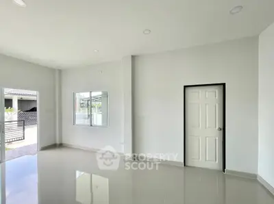 Spacious modern living room with glossy floors and ample natural light