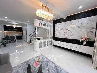 Luxurious modern living room with elegant chandelier and marble accents
