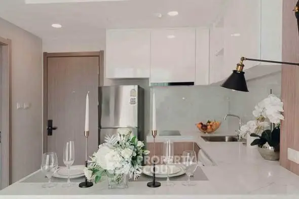 Modern kitchen with sleek white cabinets and elegant dining setup