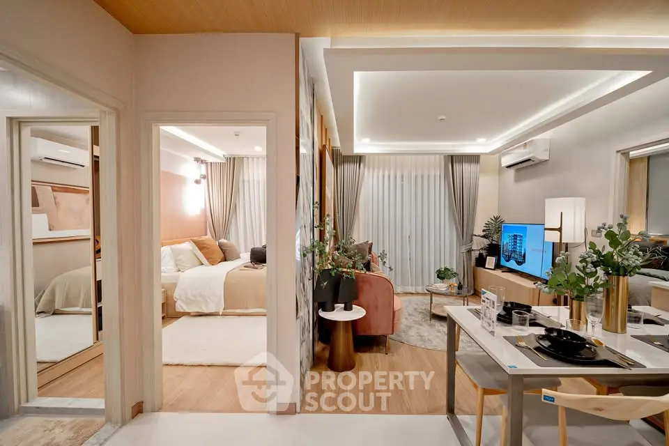 Modern open-plan living room and dining area with stylish decor and cozy bedroom view.