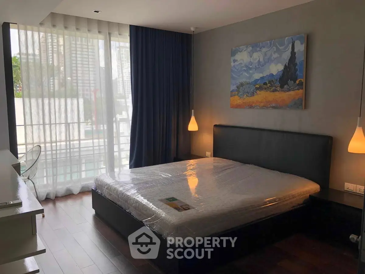 Modern bedroom with large window and stylish decor in urban apartment