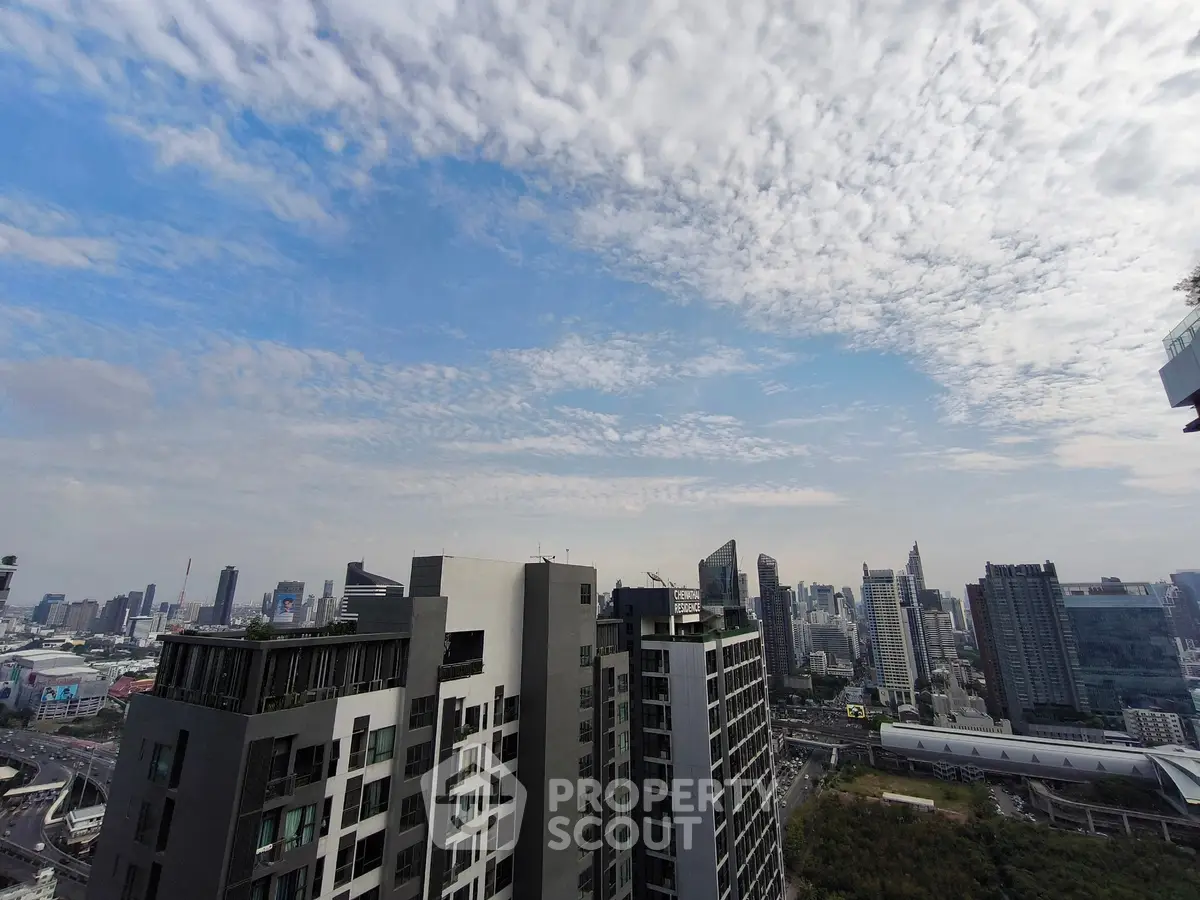 Stunning cityscape view from high-rise building balcony with expansive skyline.