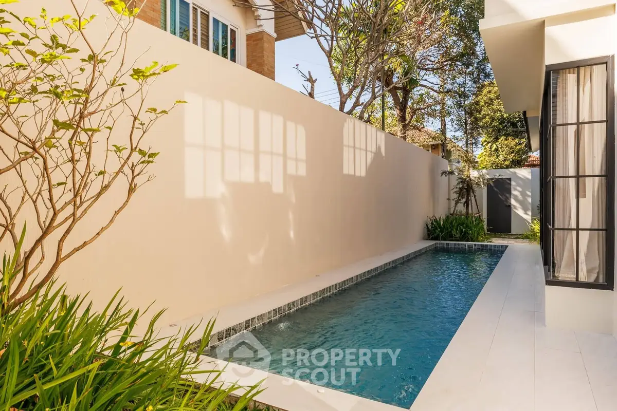 Charming private pool area with lush greenery and modern design, perfect for relaxation and outdoor enjoyment.