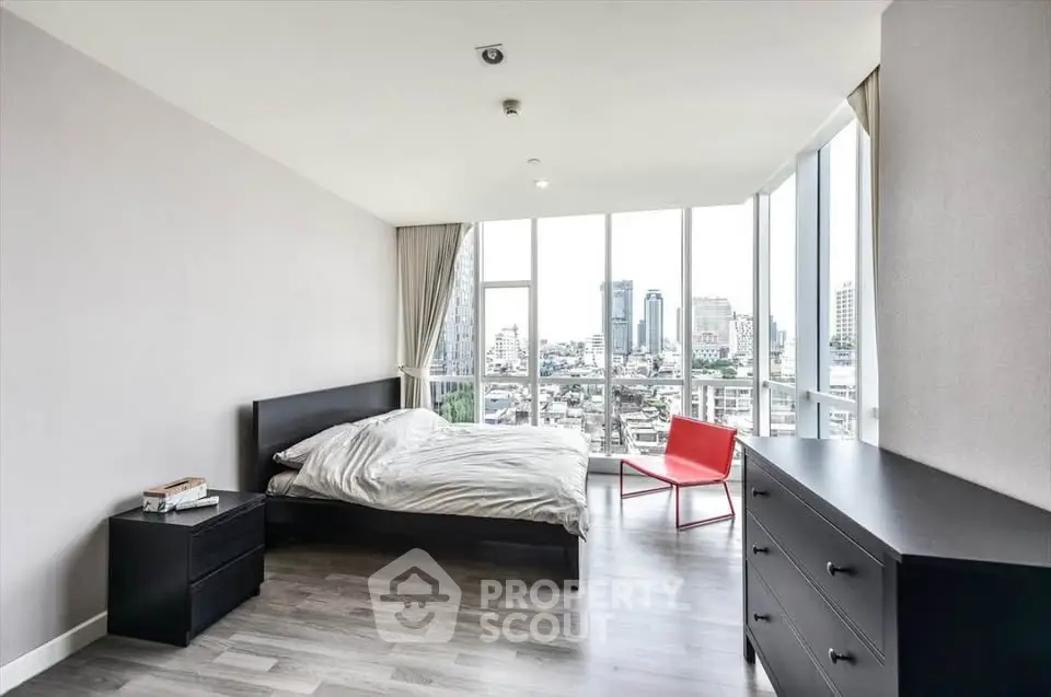 Spacious modern bedroom with city view and sleek furnishings