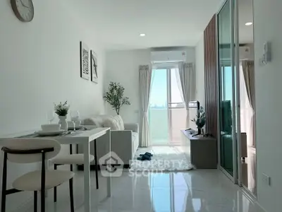 Modern living room with balcony view, stylish decor, and natural light in a contemporary apartment.