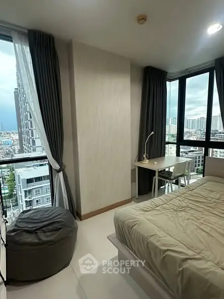 Modern bedroom with city view, large windows, and stylish decor in a high-rise apartment.