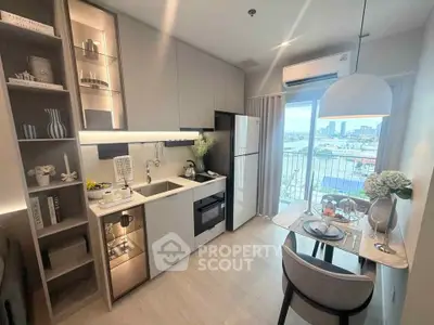 Modern kitchen with open layout and city view from balcony, featuring sleek appliances and stylish dining area.