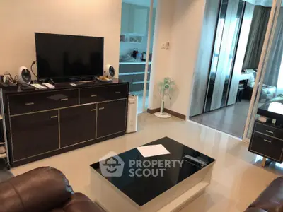 Modern living room with sleek furniture and open kitchen layout