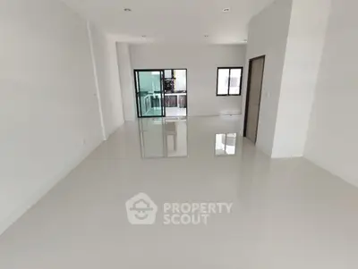 Spacious modern living room with glossy floors and large windows