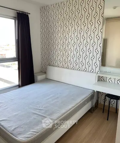 Modern bedroom with stylish wallpaper and natural light in a contemporary apartment.