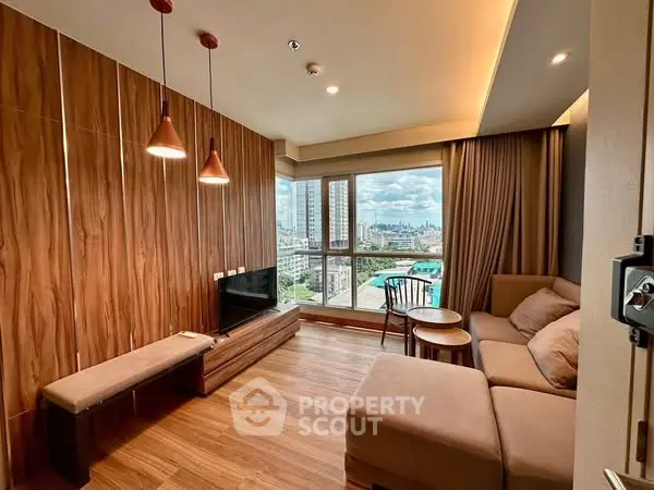 Modern living room with city view, wooden accents, and cozy seating area.