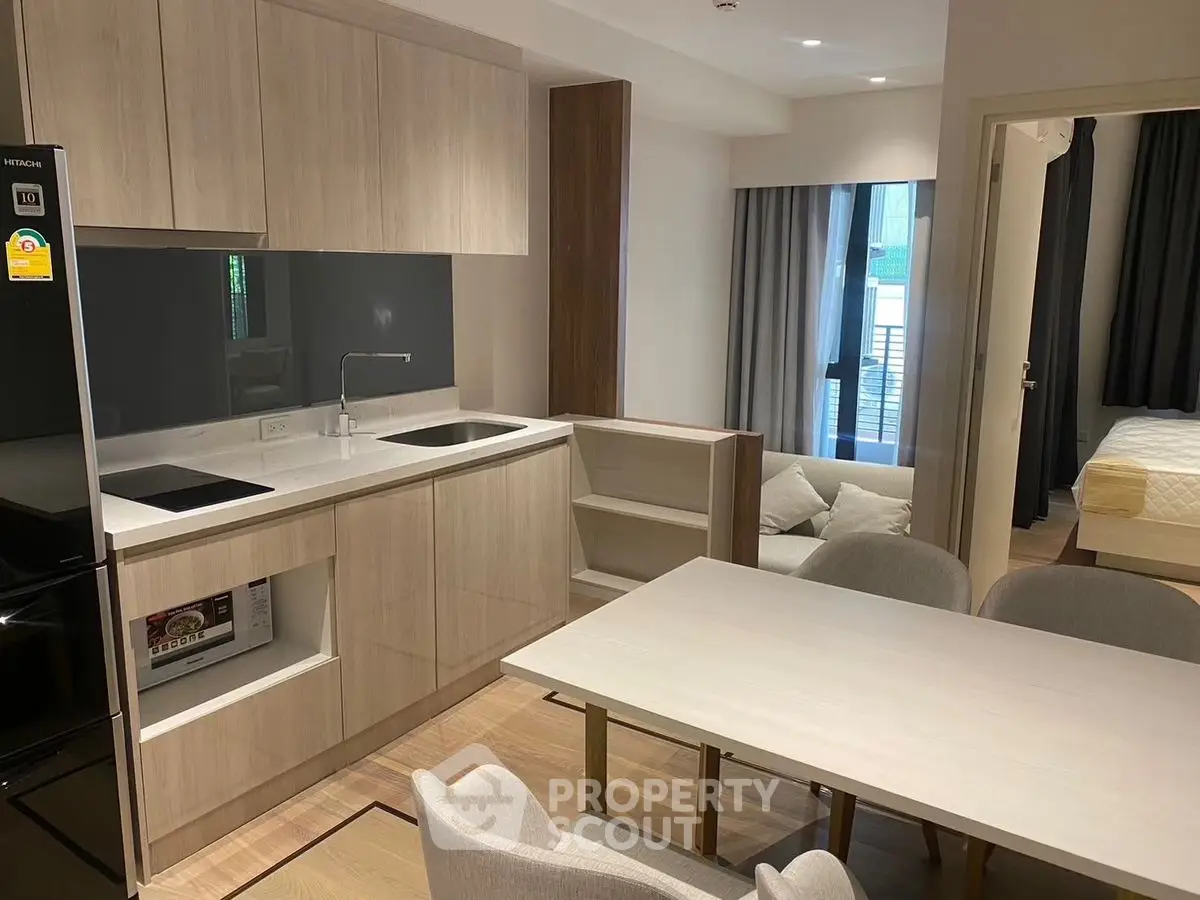 Modern open-plan kitchen and dining area with sleek design and natural light