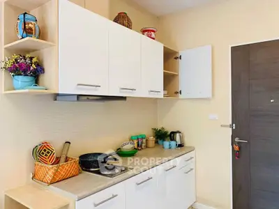 Charming kitchen with modern cabinets and cozy decor, perfect for culinary enthusiasts.