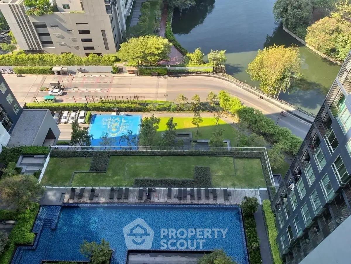 Stunning aerial view of modern residential complex with pool and lush greenery