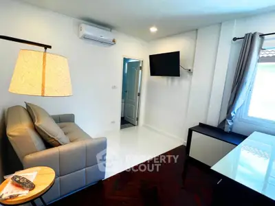 Modern living room with sleek furniture and wall-mounted TV