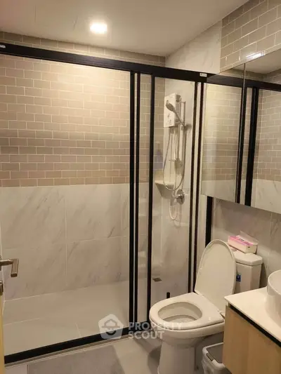 Modern bathroom with glass shower enclosure and sleek tile design