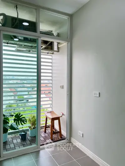 Charming balcony with city view and potted plants, perfect for relaxation.