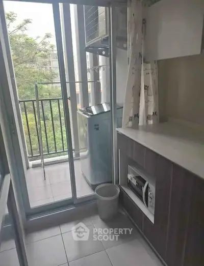 Compact balcony with laundry area and scenic view, perfect for urban living.