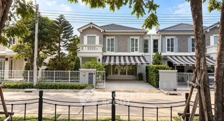 Charming suburban house with elegant facade and lush greenery, perfect for family living.