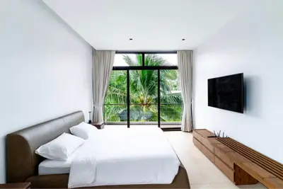 Luxurious bedroom with modern decor and stunning tropical view