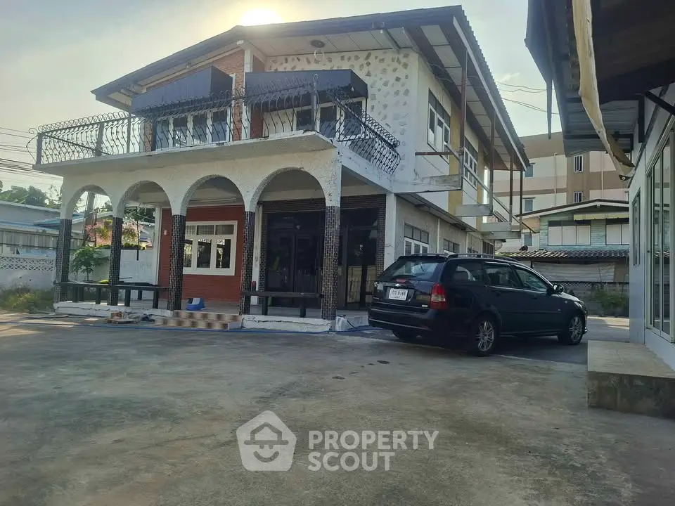 Charming two-story house with spacious driveway and elegant balcony.