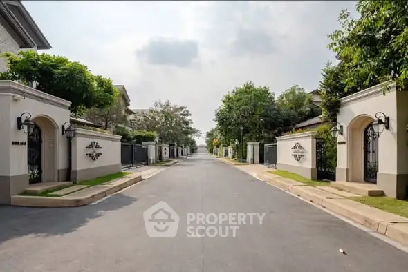 Luxurious gated community entrance with elegant landscaping and modern architecture.