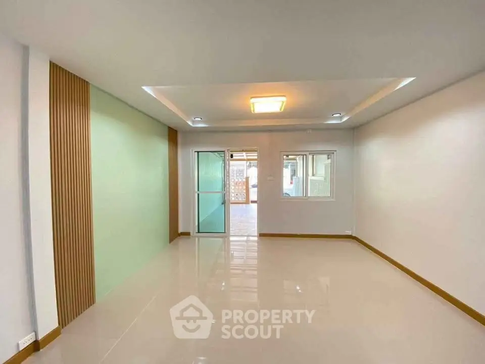 Spacious modern living room with sleek design and ample natural light.