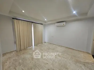 Spacious unfurnished room with marble flooring and air conditioning, ideal for customization.