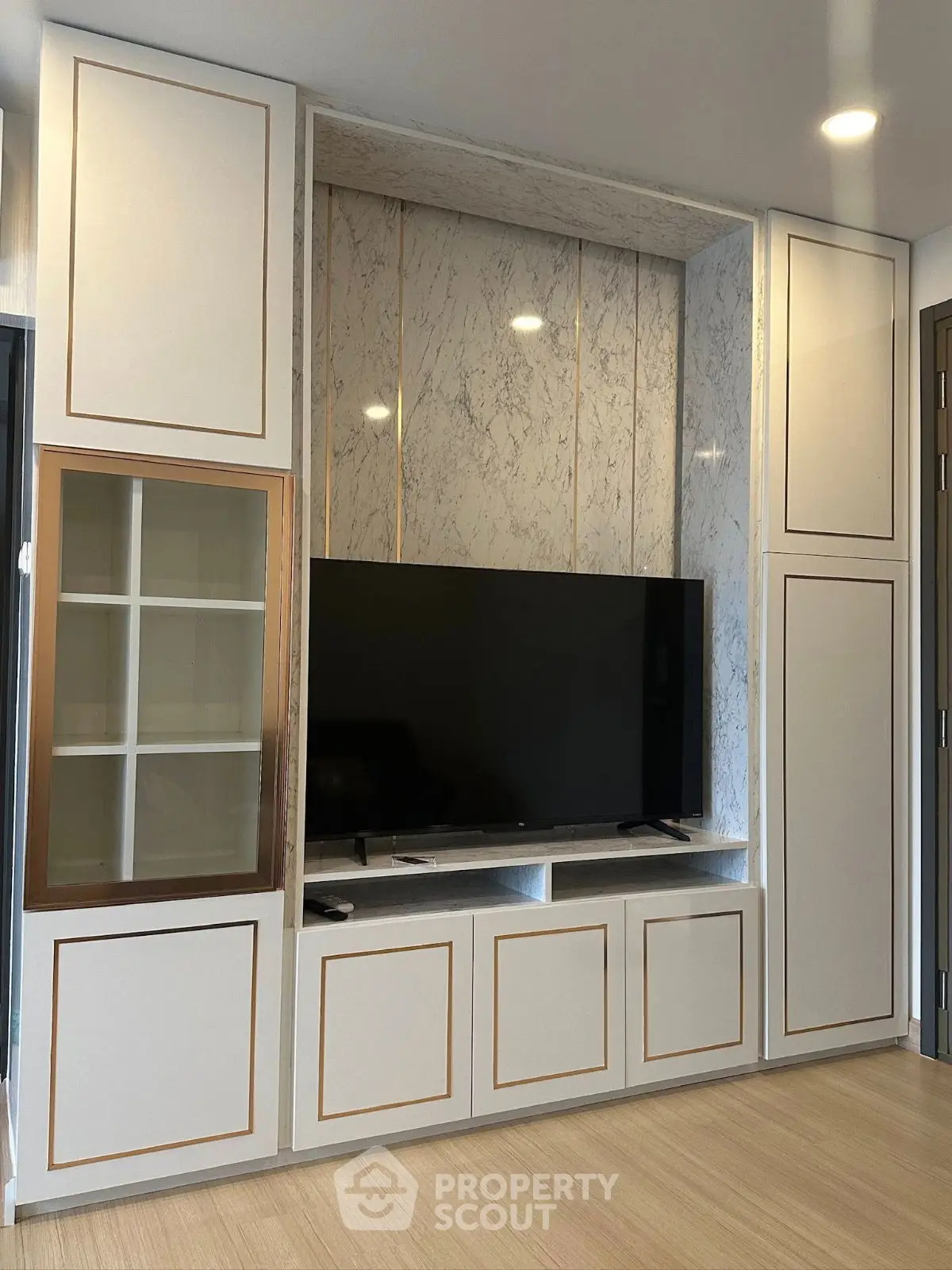 Modern living room with sleek TV unit and marble accents