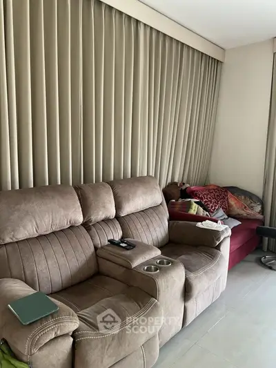 Cozy living room with plush sofa and elegant curtains