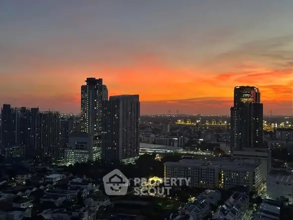 Stunning cityscape view at sunset with high-rise buildings and vibrant sky.