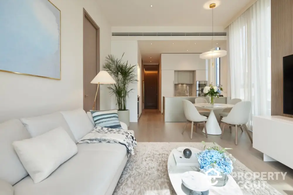 Luxurious modern living room with elegant decor and open dining area in a stylish apartment.