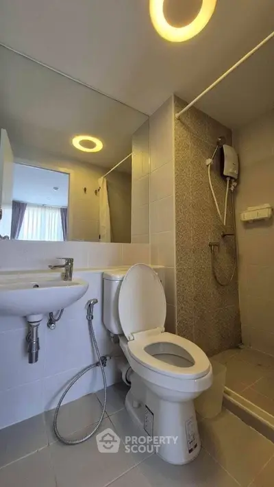 Modern bathroom with shower and large mirror in a stylish apartment.
