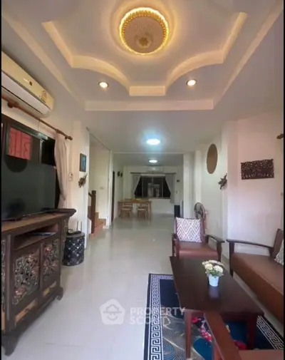 Spacious living room with elegant ceiling design and cozy seating area.