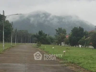 Scenic view of a misty mountain from a quiet residential street, ideal for serene living.