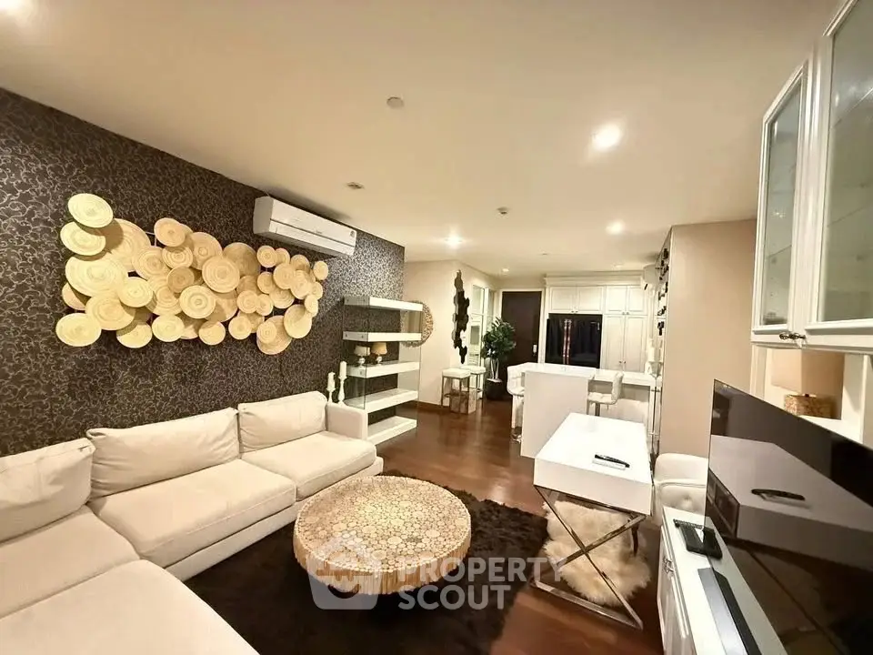 Luxurious living room with modern decor and open layout, featuring elegant furniture and ambient lighting.