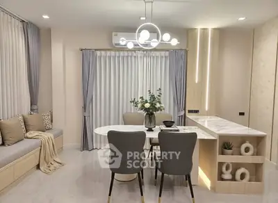 Elegant modern dining area with stylish lighting and cozy seating, perfect for intimate gatherings.