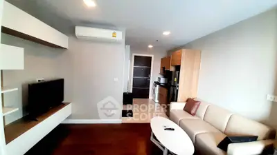 Modern living room with sleek furniture and integrated kitchen in open layout apartment