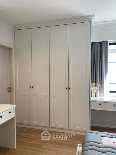 Elegant bedroom with built-in wardrobe and natural light