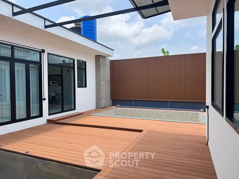 Modern home with sleek design featuring a private pool and spacious deck area.