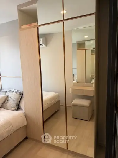 Modern bedroom with mirrored wardrobe and cozy decor