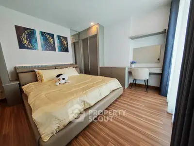 Modern bedroom with stylish decor and cozy ambiance, featuring a comfortable bed and elegant furnishings.
