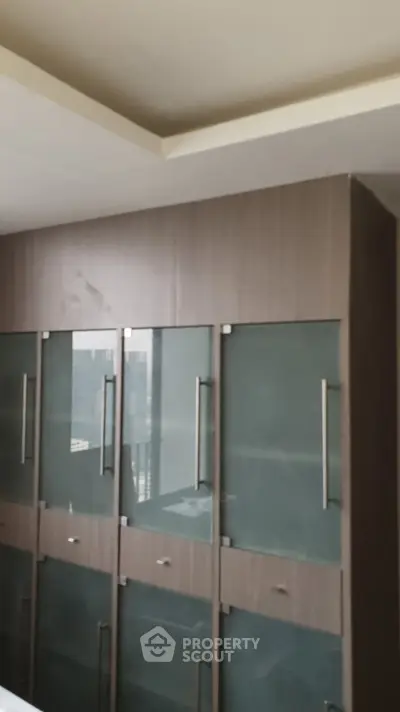 Modern kitchen with sleek glass cabinets and contemporary design.