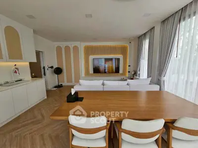 Spacious modern living room with elegant dining area and large windows.